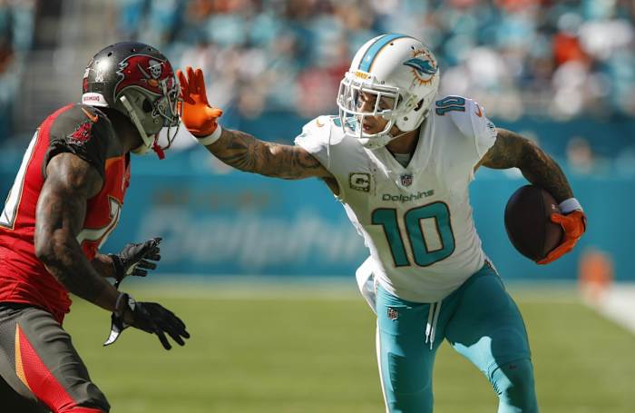 Miami Dolphins wide receiver Kenny Stills (10) stiff arms Tampa Bay cornerback Ryan Smith (29). Mandatory Credit: Reinhold Matay-USA TODAY